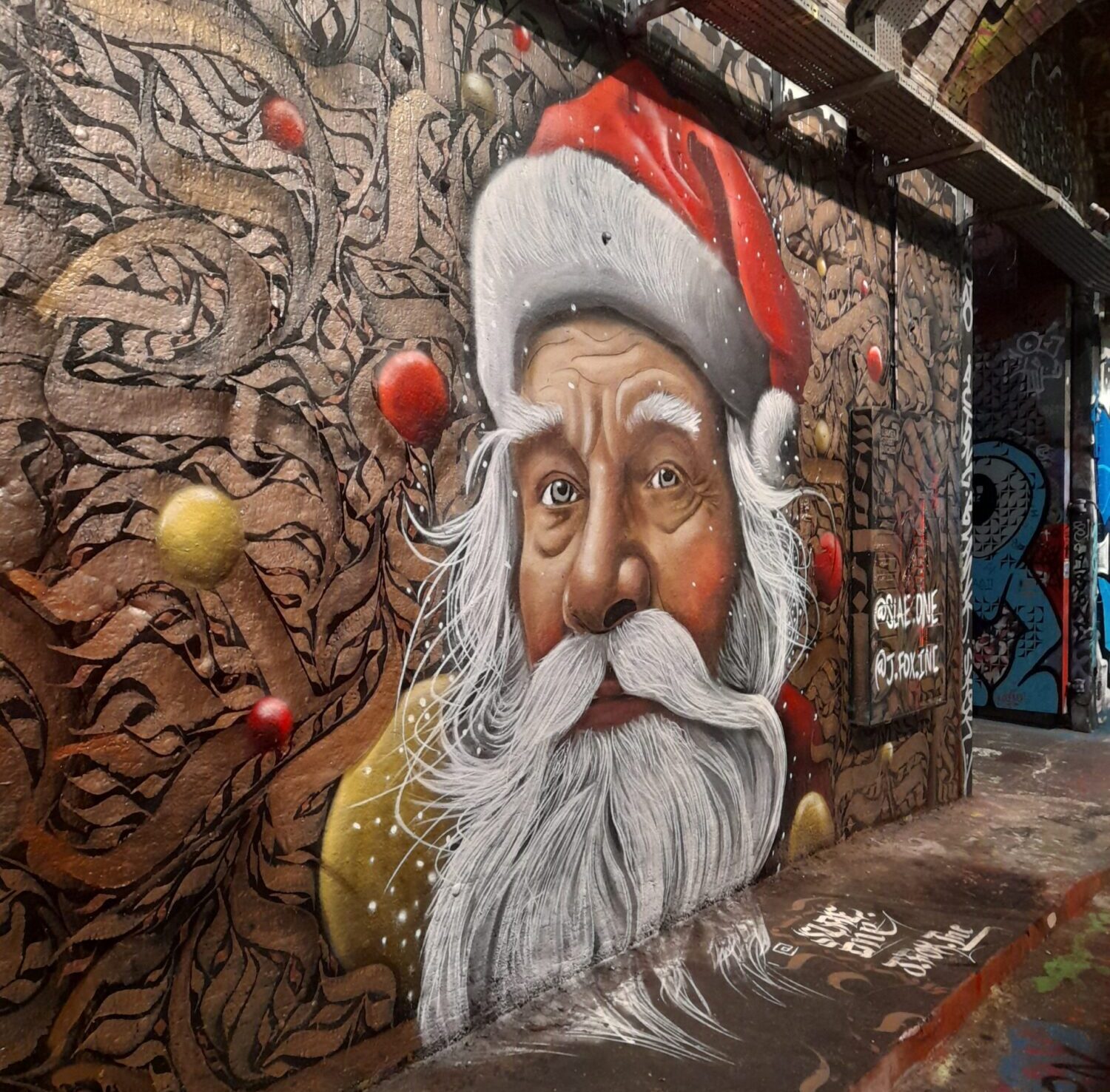 A photo of street art in London that depicts Father Christmas' face